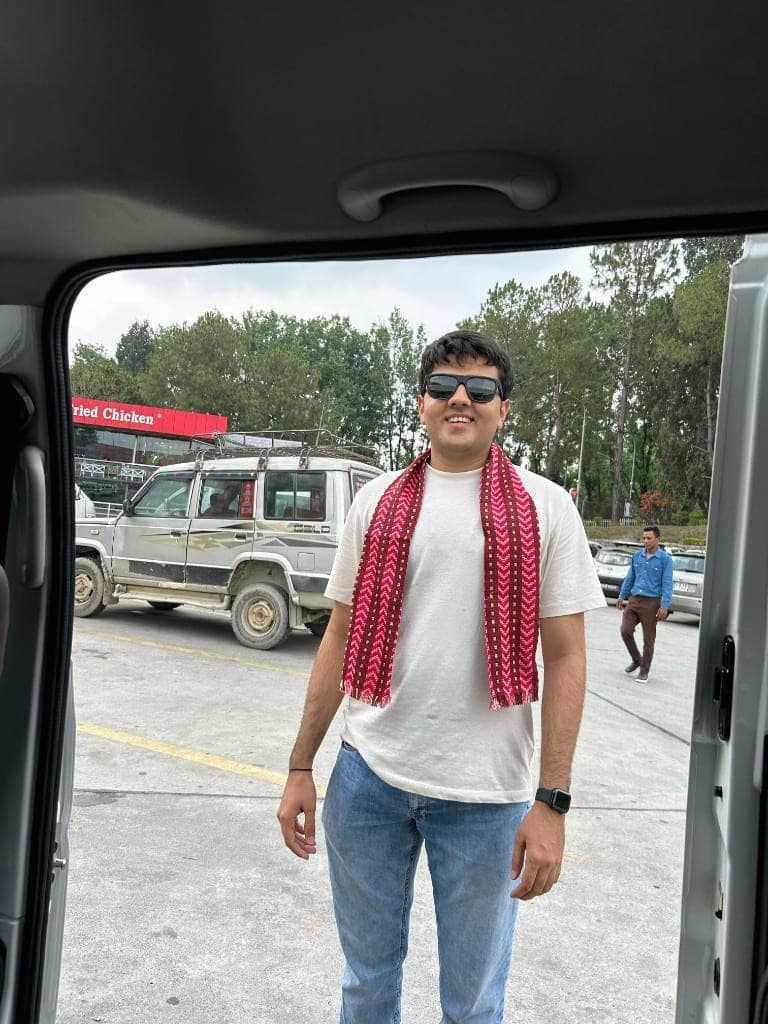 Jalaj on a road trip wearing a traditional scarf